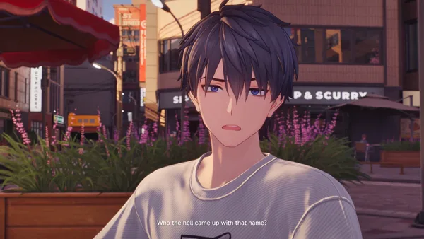 A close view of Captain in a grey shirt, with purple flowers and a café storefront behind him.